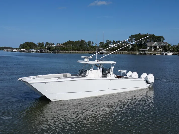  Yacht Photos Pics 2022 Freeman 37VH boat on calm water, clear sky, coastal background.