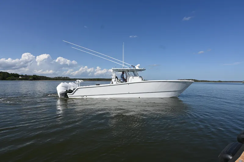  Yacht Photos Pics 2022 Freeman 37VH boat cruising on calm water under a clear blue sky.