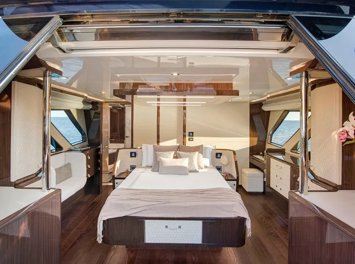  Yacht Photos Pics Luxurious 2023 Lazzara LSX yacht bedroom with elegant wood finishes and panoramic windows.