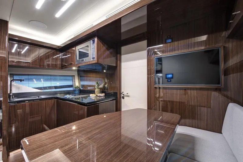  Yacht Photos Pics Luxurious 2023 Lazzara LSX yacht interior with modern kitchen and dining area.