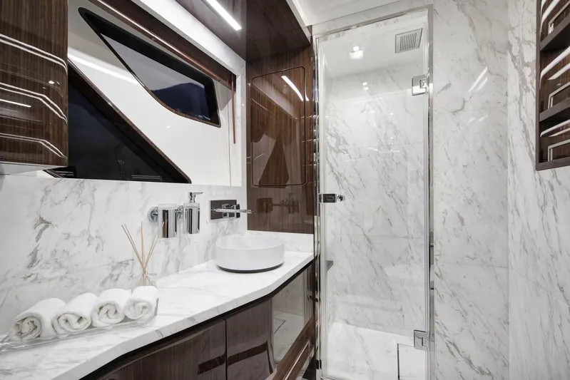  Yacht Photos Pics Luxurious 2023 Lazzara LSX yacht bathroom with marble and wood finishes.