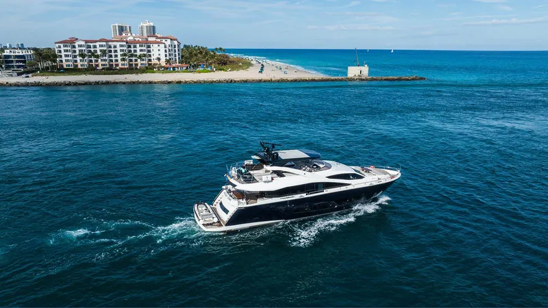 Golden Ours Yacht Photos Pics Luxurious 2019 Sunseeker motoryacht cruising near a coastal resort.