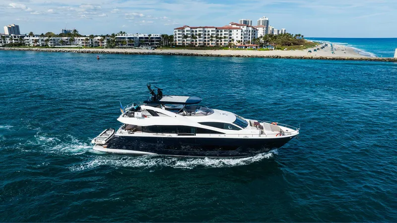 Golden Ours Yacht Photos Pics Luxurious 2019 Sunseeker motoryacht cruising near coastal cityscape.