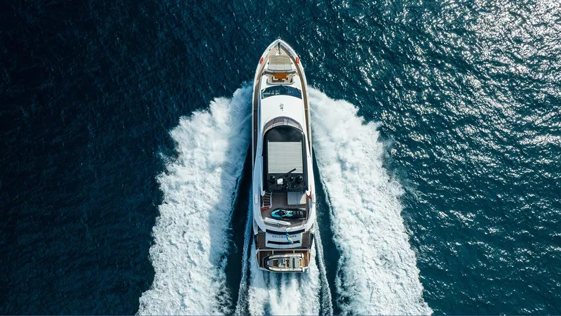 Golden Ours Yacht Photos Pics Aerial view of 2019 Sunseeker motoryacht cruising on open blue sea.