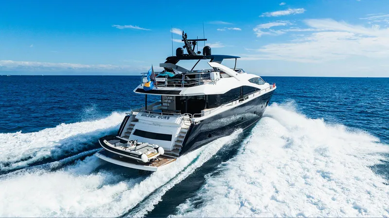 Golden Ours Yacht Photos Pics Luxurious 2019 Sunseeker motoryacht cruising on open sea under clear blue sky.
