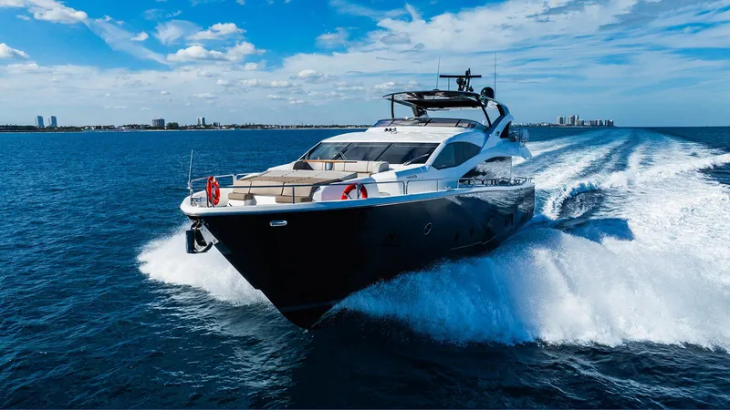 Golden Ours Yacht Photos Pics Luxurious 2019 Sunseeker Motoryacht cruising on open water under a clear blue sky.