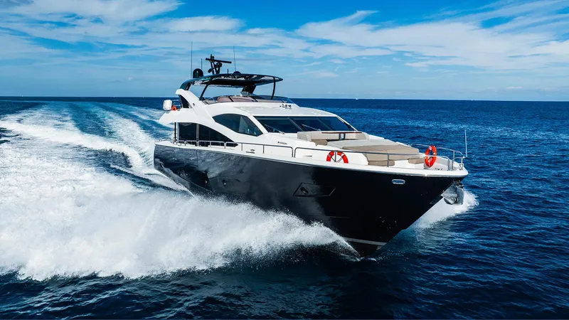 Golden Ours Yacht Photos Pics 2019 Sunseeker Motoryacht cruising on open sea under clear blue sky.