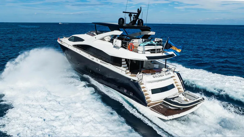 Golden Ours Yacht Photos Pics Luxurious 2019 Sunseeker motoryacht cruising on open sea, creating dynamic waves.