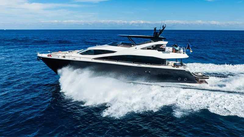 Golden Ours Yacht Photos Pics 2019 Sunseeker Motoryacht cruising on open sea, creating waves under clear blue sky.