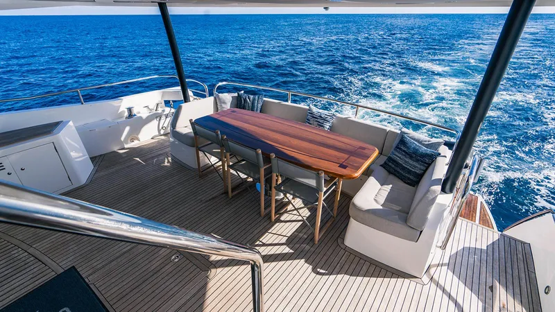 Golden Ours Yacht Photos Pics 2019 Sunseeker Motoryacht deck with dining area overlooking the ocean.