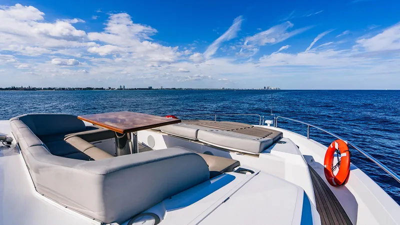 Golden Ours Yacht Photos Pics Luxurious 2019 Sunseeker motoryacht deck with seating, table, and ocean view.