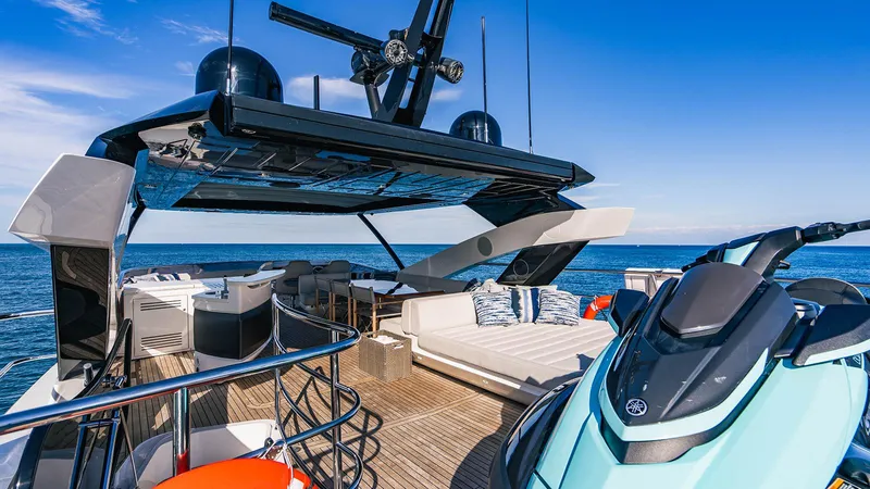 Golden Ours Yacht Photos Pics Luxurious 2019 Sunseeker Motoryacht deck with seating and jet ski, cruising on open sea.