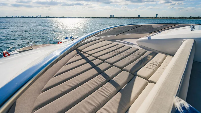 Golden Ours Yacht Photos Pics Luxurious 2019 Sunseeker Motoryacht deck with sunbeds overlooking serene ocean view.