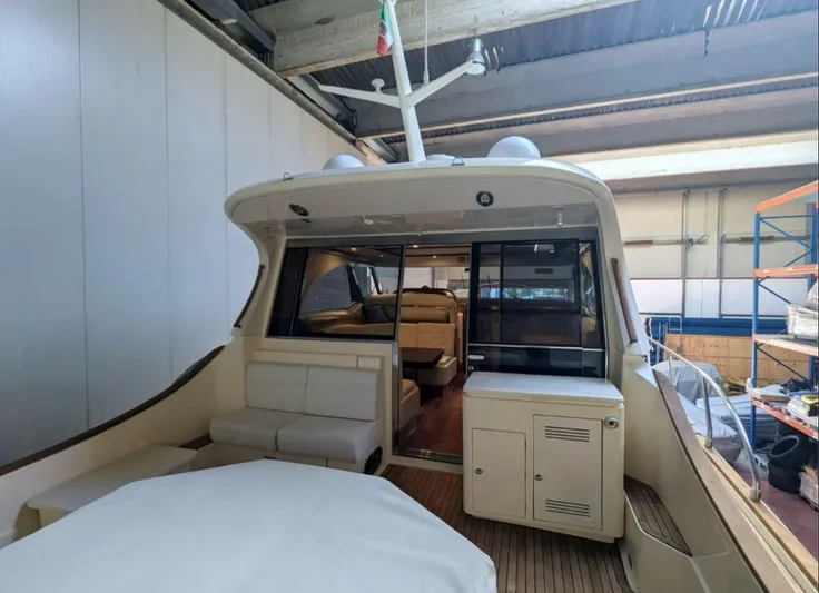  Yacht Photos Pics 2006 Mochi Craft 51 Dolphin yacht interior with seating and storage in a covered dock.