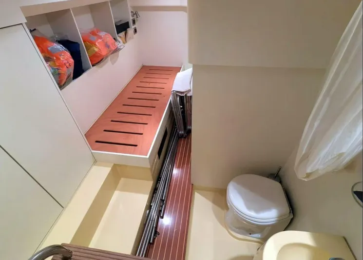  Yacht Photos Pics Interior of 2006 Mochi Craft 51 Dolphin yacht, featuring a compact bathroom and storage area.