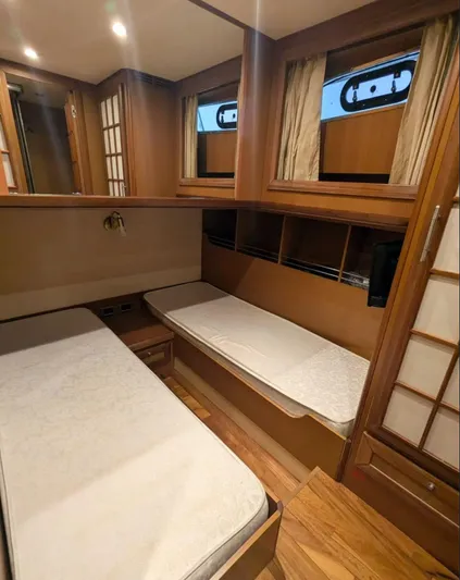  Yacht Photos Pics Interior of 2006 Mochi Craft 51 Dolphin yacht with twin beds and wooden furnishings.