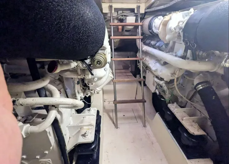  Yacht Photos Pics Engine room of 2006 Mochi Craft 51 Dolphin yacht with visible machinery and ladder.