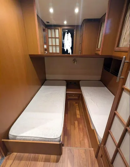  Yacht Photos Pics Interior cabin of 2006 Mochi Craft 51 Dolphin yacht with twin beds and wooden finish.