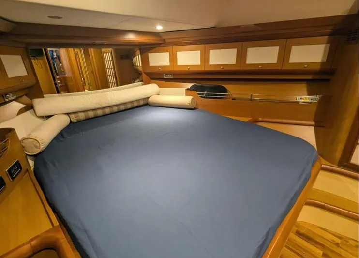  Yacht Photos Pics Luxurious cabin interior of 2006 Mochi Craft 51 Dolphin yacht with blue bedding.