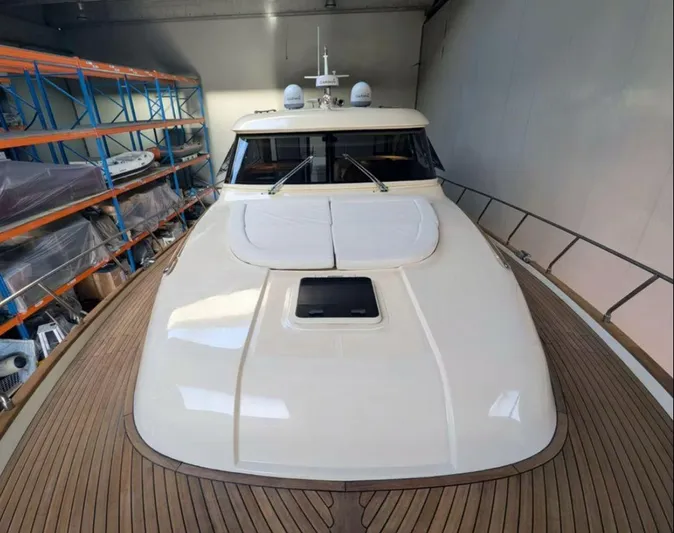  Yacht Photos Pics 2006 Mochi Craft 51 Dolphin yacht in storage, showcasing sleek design and spacious deck.