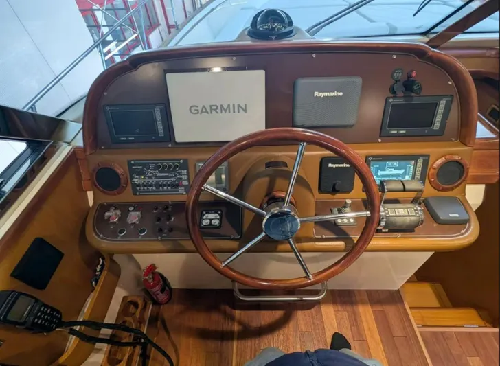  Yacht Photos Pics Cockpit of 2006 Mochi Craft 51 Dolphin with Garmin and Raymarine navigation systems.