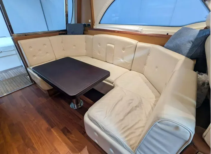  Yacht Photos Pics Luxurious interior of 2006 Mochi Craft 51 Dolphin yacht with plush seating and wooden flooring.