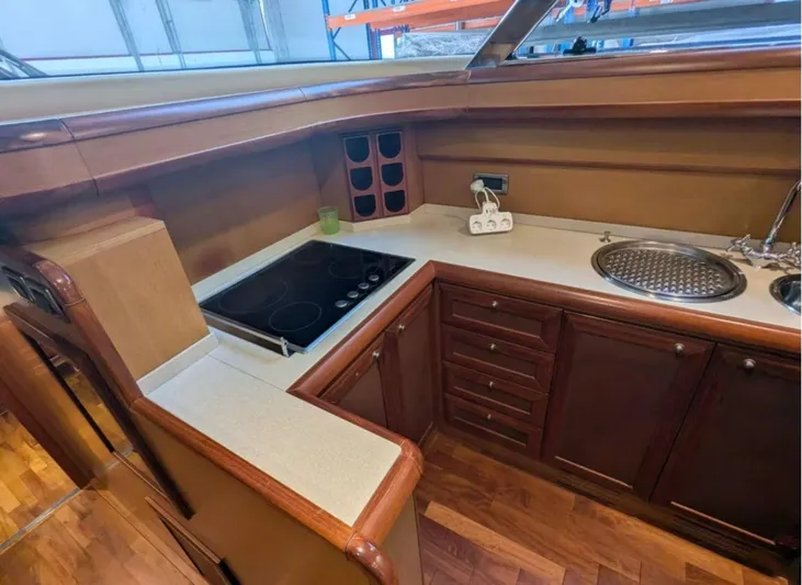  Yacht Photos Pics Luxurious kitchen interior of 2006 Mochi Craft 51 Dolphin yacht with wooden cabinetry.