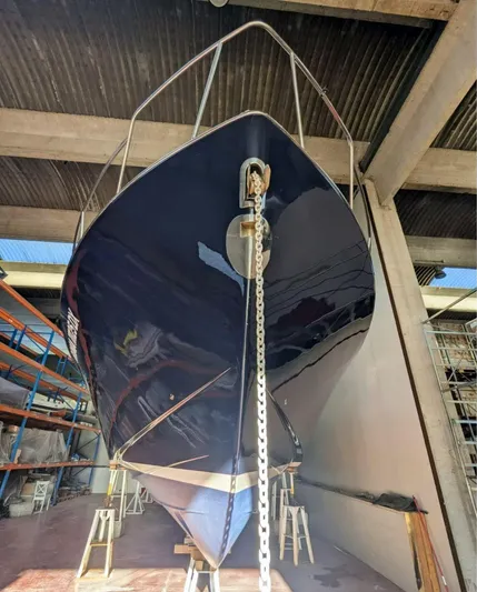  Yacht Photos Pics 2006 Mochi Craft 51 Dolphin yacht in dry dock, showcasing sleek hull design.