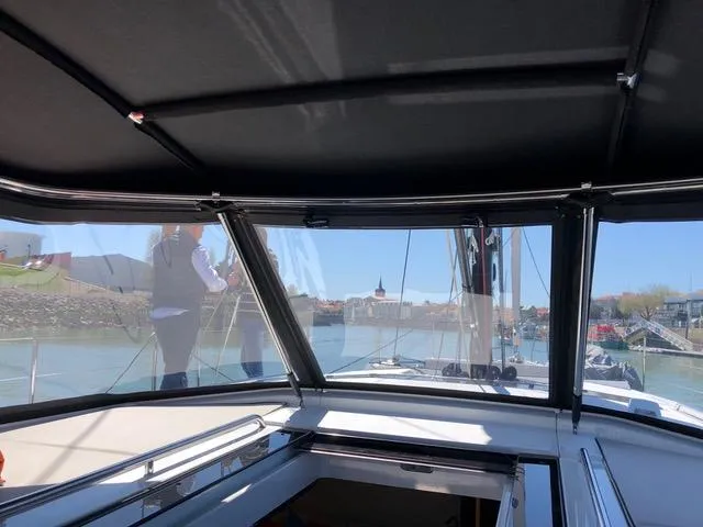 Manona (name Reserved For Owner) Yacht Photos Pics Interior view from a 2018 Beneteau Oceanis Yacht 62, showcasing marina and waterfront scenery.