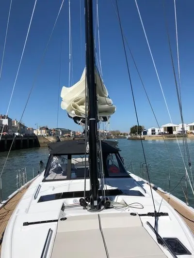 Manona (name Reserved For Owner) Yacht Photos Pics 2018 Beneteau Oceanis Yacht 62 sailing on a sunny day in a marina.