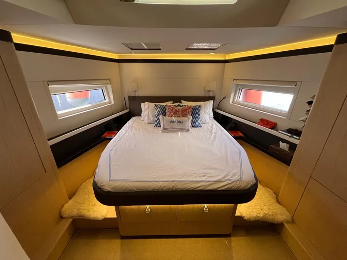 Manona (name Reserved For Owner) Yacht Photos Pics Luxurious bedroom interior of 2018 Beneteau Oceanis Yacht 62 with modern design and cozy bedding.