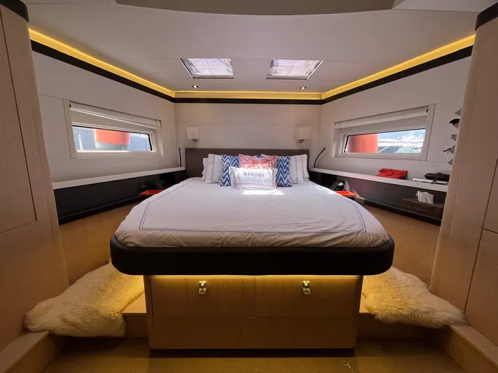 Manona (name Reserved For Owner) Yacht Photos Pics Luxurious bedroom interior of 2018 Beneteau Oceanis Yacht 62 with modern design and cozy lighting.