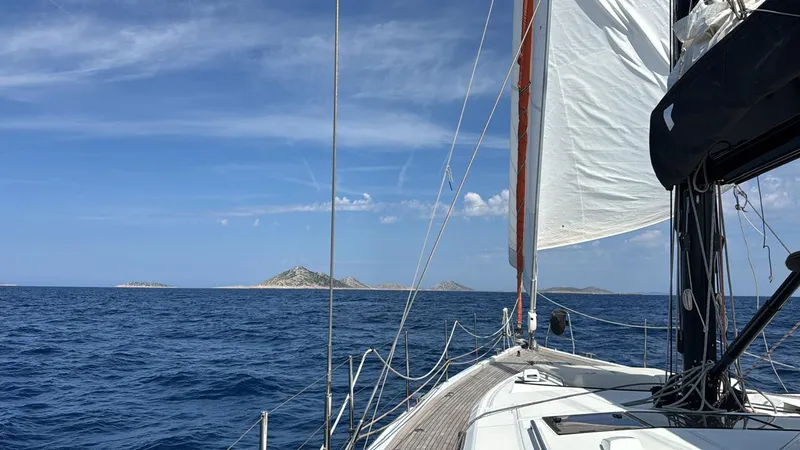 Manona (name Reserved For Owner) Yacht Photos Pics Sailing on a 2018 Beneteau Oceanis Yacht 62 with island views and clear blue skies.