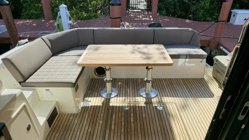  Yacht Photos Pics Prestige 460 yacht 2018 model, featuring a spacious outdoor seating area with a wooden table.