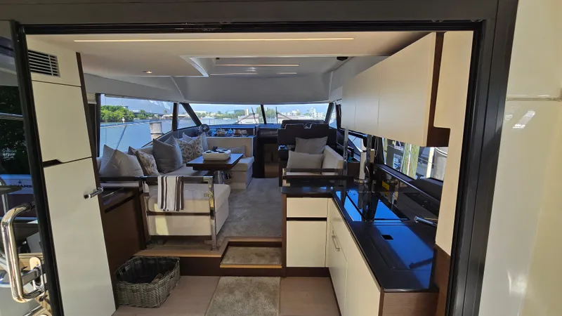  Yacht Photos Pics Luxurious interior of a 2018 Prestige 460 yacht, featuring modern seating and sleek kitchen area.