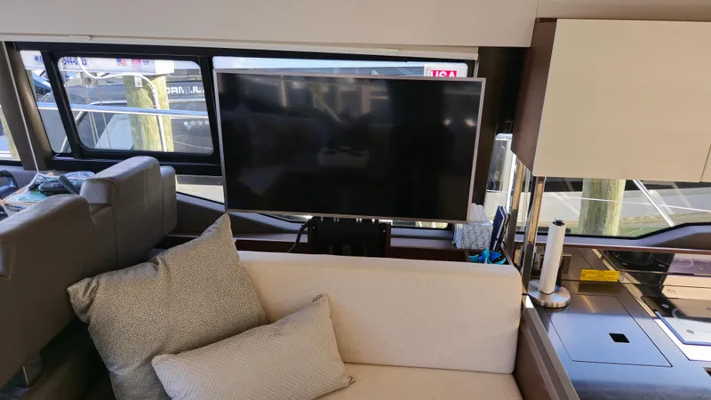  Yacht Photos Pics Interior of 2018 Prestige 460 yacht with TV, sofa, and modern decor.