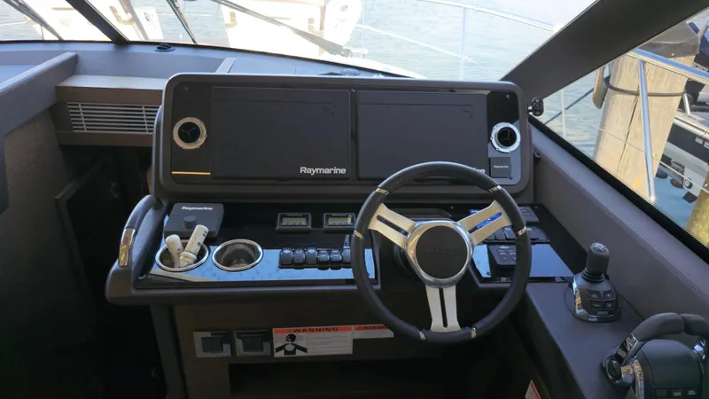  Yacht Photos Pics Helm of 2018 Prestige 460 yacht with Raymarine navigation system and steering wheel.