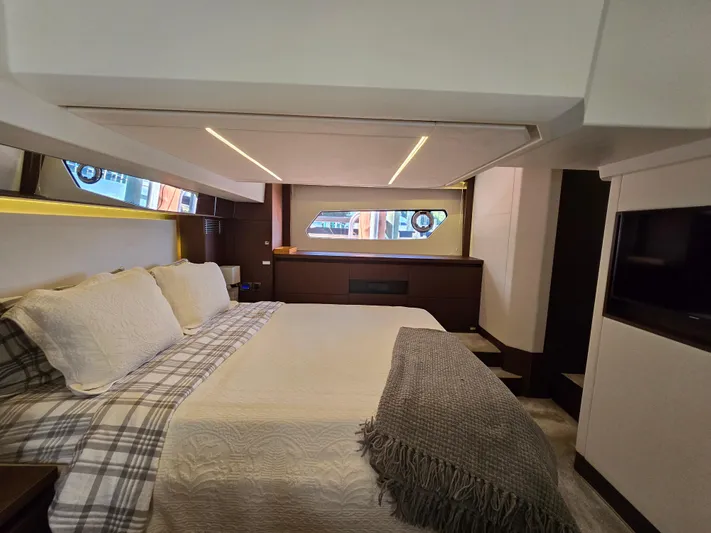  Yacht Photos Pics Luxurious bedroom interior of a 2018 Prestige 460 yacht with modern design and cozy bedding.