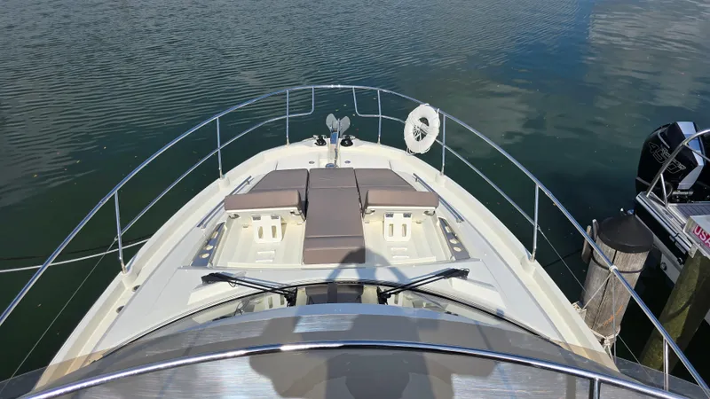  Yacht Photos Pics 2018 Prestige 460 yacht bow with sun loungers and calm water view.