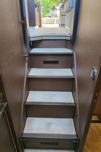  Yacht Photos Pics Staircase inside 2018 Prestige 460 yacht, leading to upper deck with modern interior design.