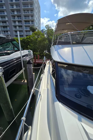  Yacht Photos Pics Prestige 460 yacht docked near high-rise, sunny day, 2018 model.