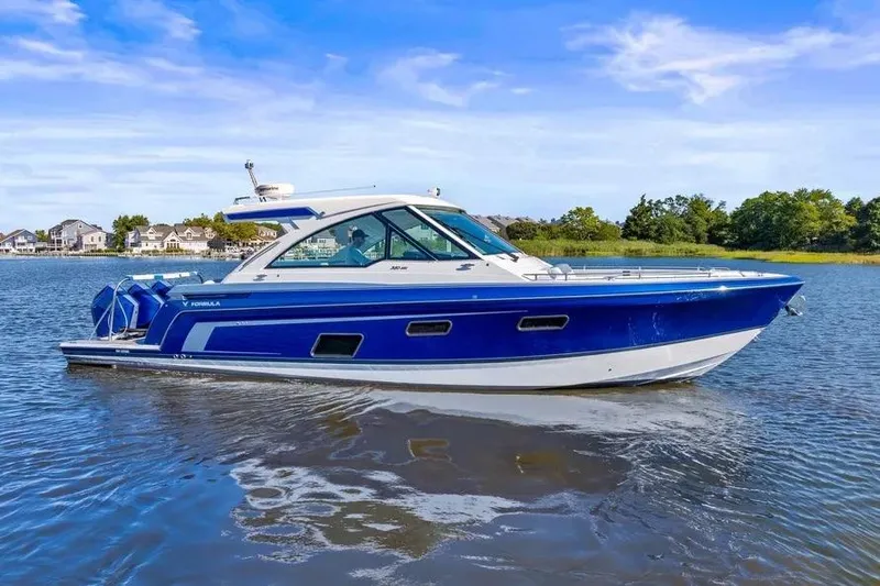  Yacht Photos Pics 2024 Formula 380 Super Sport Crossover OB cruising on a serene lake.