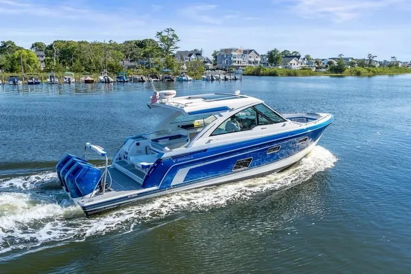  Yacht Photos Pics 2024 Formula 380 Super Sport Crossover OB cruising on a scenic lake.