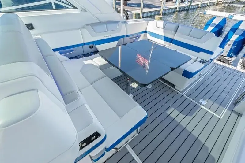  Yacht Photos Pics 2024 Formula 380 Super Sport Crossover OB interior with sleek seating and modern table design.