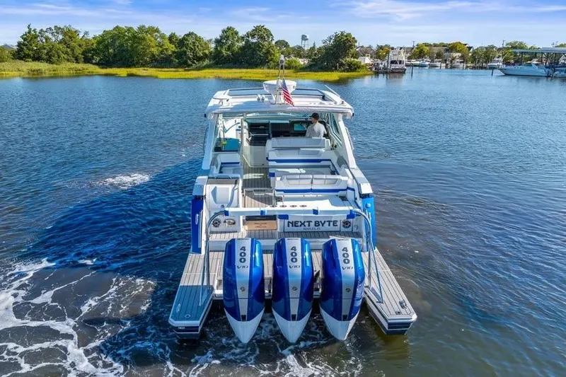  Yacht Photos Pics 2024 Formula 380 Super Sport Crossover OB cruising on a serene lake.
