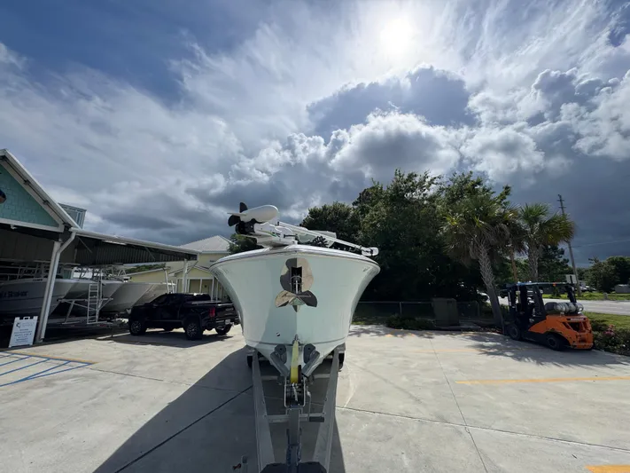  Yacht Photos Pics 2023 Sailfish 312 CC boat on trailer under cloudy sky.