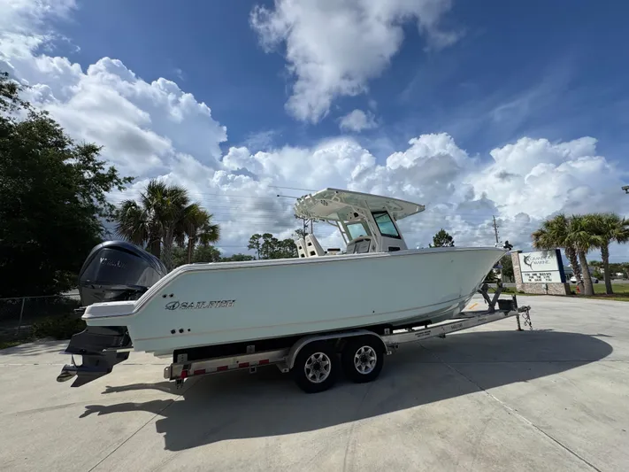  Yacht Photos Pics 2023 Sailfish 312 CC boat on trailer under cloudy sky.