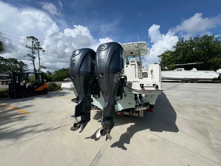 Yacht Photos Pics 2023 Sailfish 312 CC boat with dual outboard engines in a sunny outdoor setting.