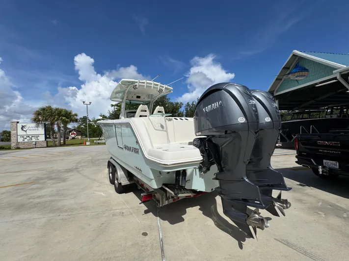  Yacht Photos Pics 2023 Sailfish 312 CC boat with dual Yamaha engines in a marina setting.