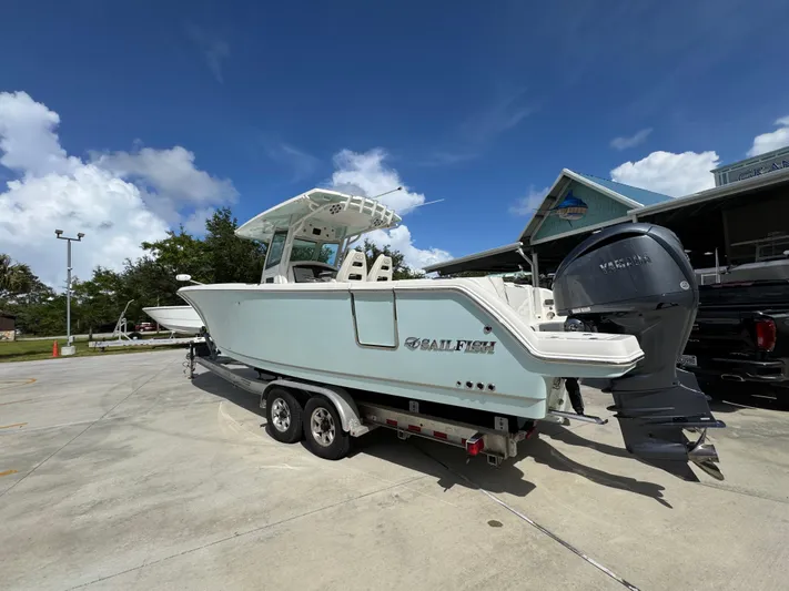  Yacht Photos Pics 2023 Sailfish 312 CC boat on trailer with Yamaha outboard motor.